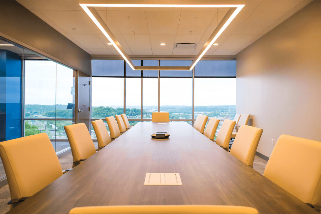 conference room with a large table and chairs, a modern-style square light fixture, and floor-to-ceiling windows