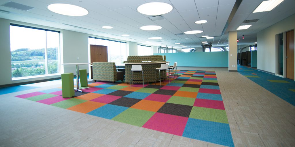 collaborative workspace with colorful carpet and furniture