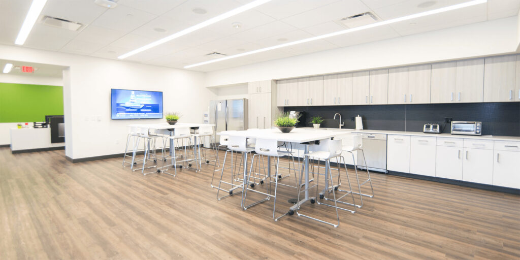 café/break area with bright white walls, and white tables and chairs