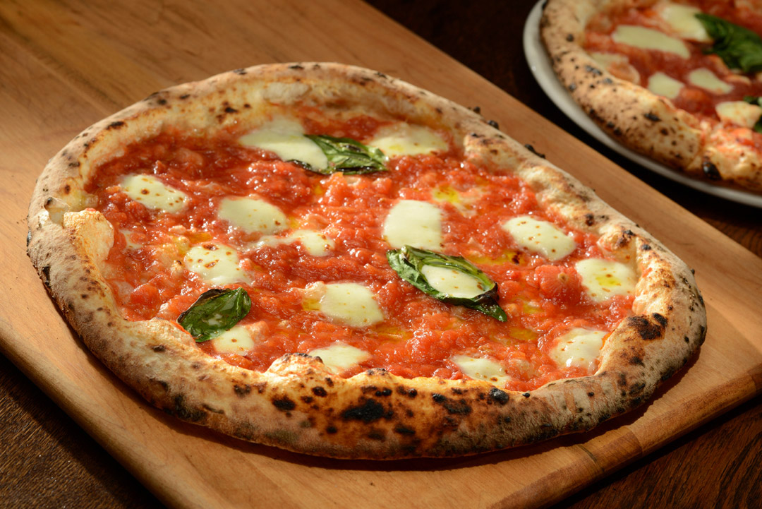 Margarita pizza on a cutting board